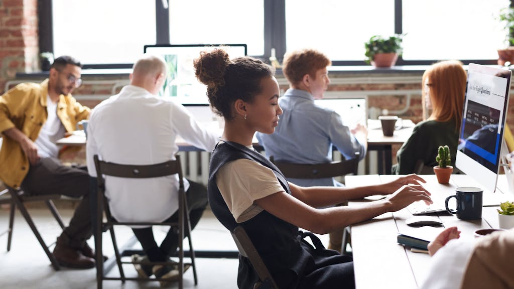 Woman in White and Black Top Using Computer